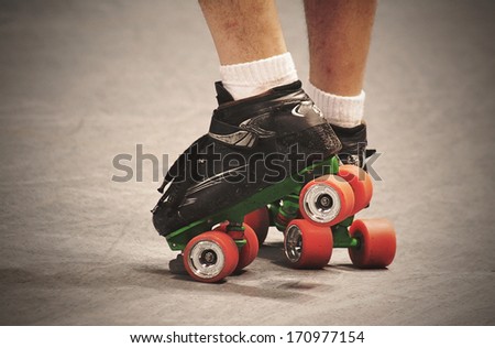 a pair of legs in roller skates vintage toned and textured for a