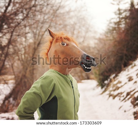 a woman in a horse head mask