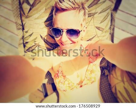 a cute girl smiling at the camera on a bright sunny day done with a retro vintage instagram filter