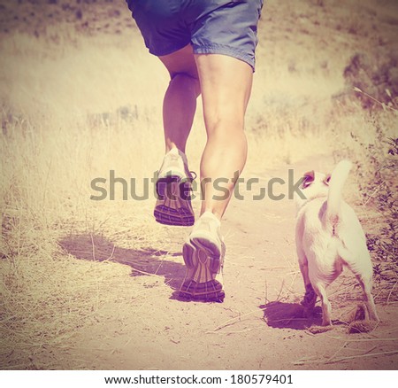 a woman with an athletic pair of legs going for a jog on grass during sunrise or sunset - healthy lifestyle concept done with an instagram like filter