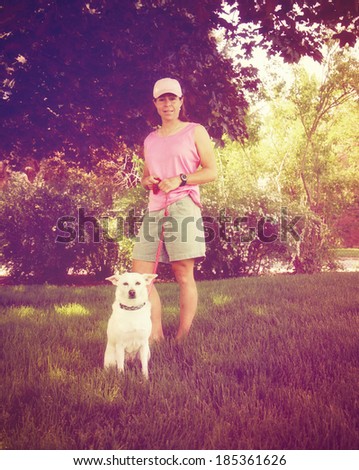 a cute girl and her dog on a lawn done with a retro vintage instagram filter
