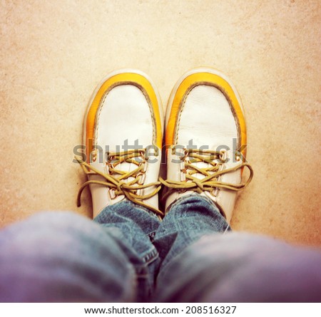a shot of yellow and white boat or deck shoes toned with a retro vintage instagram filter