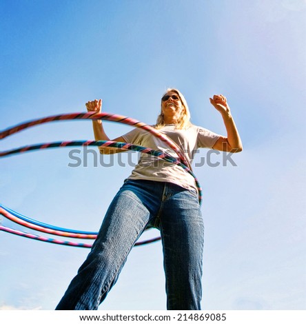 a woman hula hooping on a clear day
