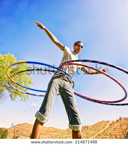 a young man hula hooping in a local park