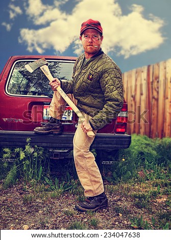 a redneck man with an axe in his hands toned with a retro vintage instagram filter effect