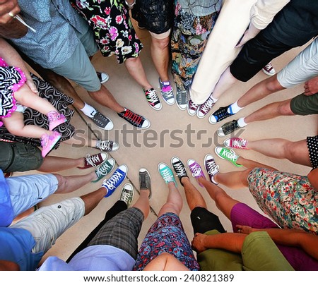 a group of friends with their legs in a complete circle