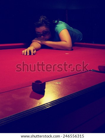 a girl in a bar leaning on a pool table toned with a retro vintage instagram filter effect app or action