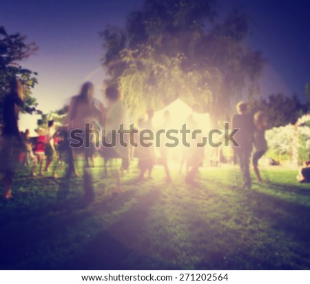 people mingling at a free concert by local musicians in a garden st night with a long exposure toned with a retro vintage instagram filter effect app or action