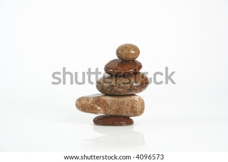 five rocks balancing on a white background