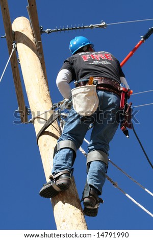 An Electrical Lineman Student Working On A Pole At A Lineman College ...