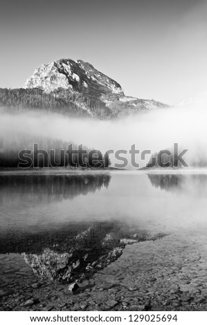 Morning mountain landscape with fog the lake black and white