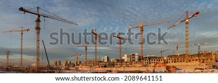 Panoramic view of a large construction site with many tower cranes. New residential area of a big city ストックフォト © 