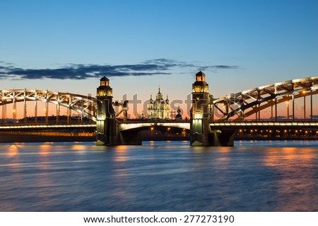 Peter the Great Bridge and Smolny Cathedral in Saint-Petersburg with lights in the summer night