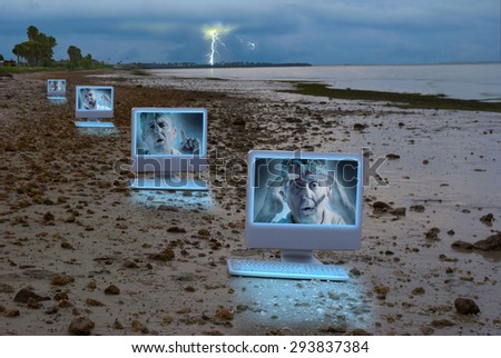 Computers on a stormy rocky shoreline with a man on the screens showing many emotions illustrating social media legal issues, computer bullying, computer problems, hacking malware security issues.