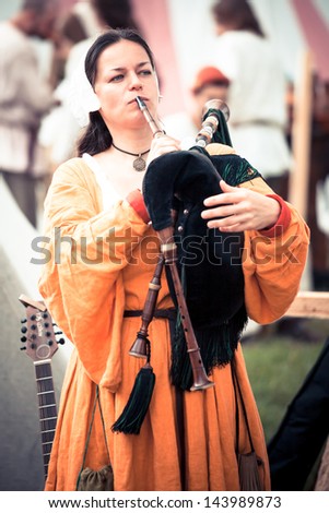 MOSCOW/RUSSIA - JUNE 23: Musician woman in historical dress plays bagpipe during great international festival of historical reconstruction \