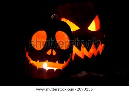 Jack-o-lanterns, two Halloween pumpkins glowing in the night