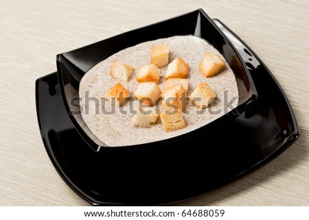 Mushroom cream soup with pieces of toasted bread, room for copy.