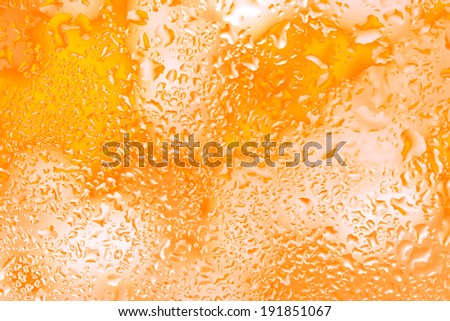 Yellow water droplets on glass,Bright color background