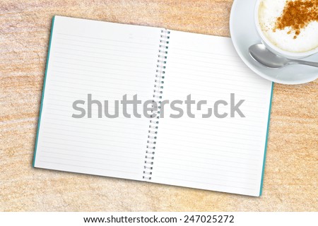 Blank book with coffee on the stone sand table