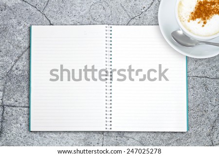 Blank book with coffee on the stone table