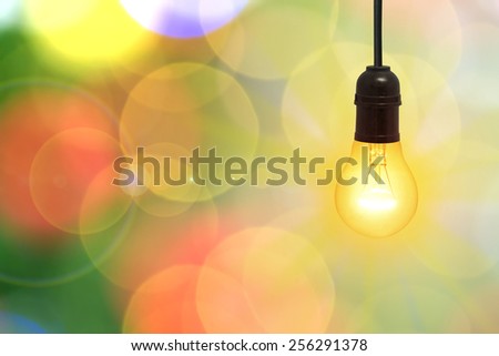 Lighting decor,bulb,The creative success Like a lamp with a beam of light on the background of beautiful bokeh.