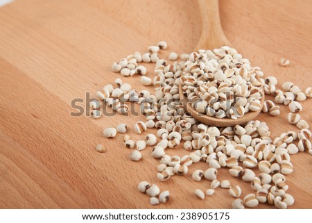 Job\'s tears with wooden spoon on wood background