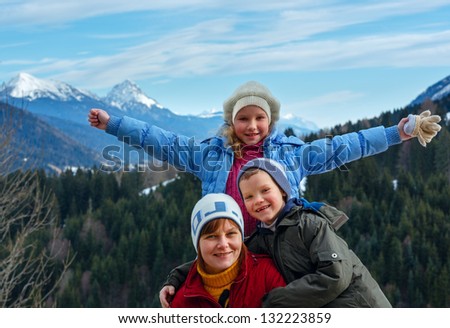 Family on winter mountain background.  View from Obergail village outskirts in Lesachtal (Austria).