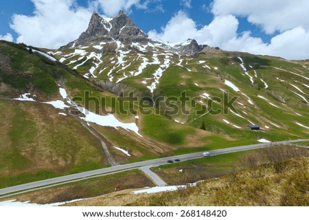 Summer mountain sunny landscape with snow on slope (Warth, Austria)