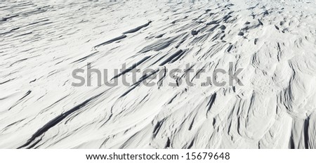 Snowdrifts wind formed texture on mountain top (three shots stitch image)