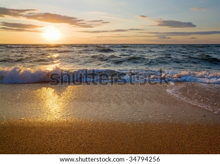 Sea  sunset surf great wave break on sandy coastline