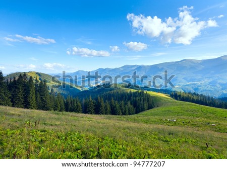 Summer mountain plateau landscape with dirty road on hill top