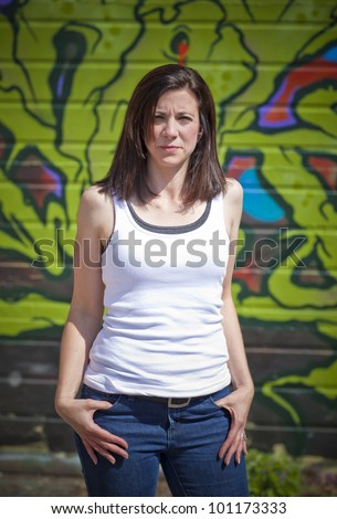 Beautiful woman in front of a graffiti covered wall