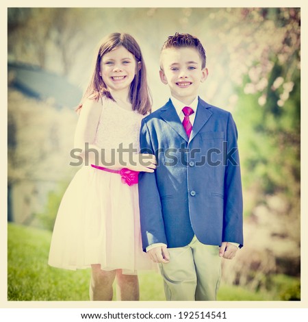 A young boy and girl standing outside portrait with Instagram effect filter