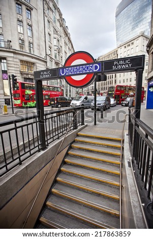 LONDON, UK - AUG 22, 2014: London Underground Monument Station entrance and signage. The London Underground sign is a famous London icon.