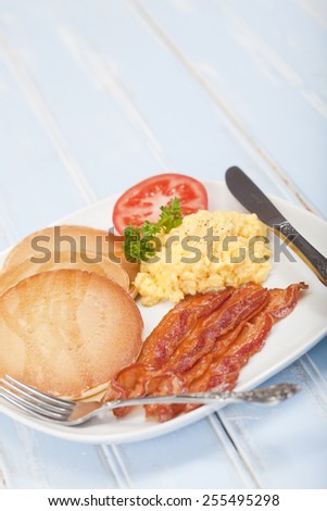 American style breakfast of pancakes, bacon and eggs