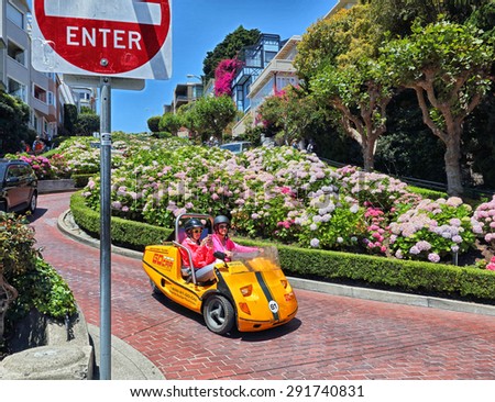 San Francisco, CA, USA - June 23rd, 2015: Tourists in a GoCar driving down San Francisco\'s famous winding Lombard Street.