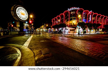 San Francisco, CA, USA - June 25th, 2015: Famous Fisherman\'s Wharf street and signage at night and Applebee\'s restaurant.