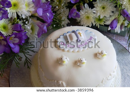 Celebration cake surrounded by mixed colorful flowers