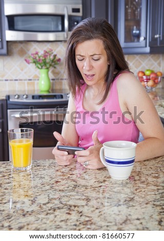 Attractive woman wearing pajamas texting on cellphone