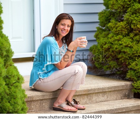 Beautiful woman taking a coffee break holding a mug