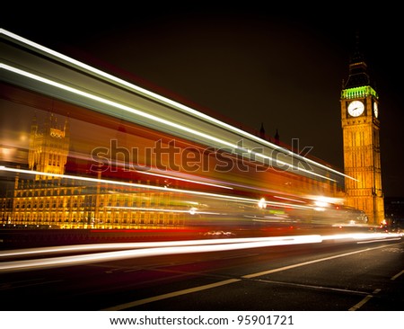Westminster Bridge in London at night with Big Ben and bus