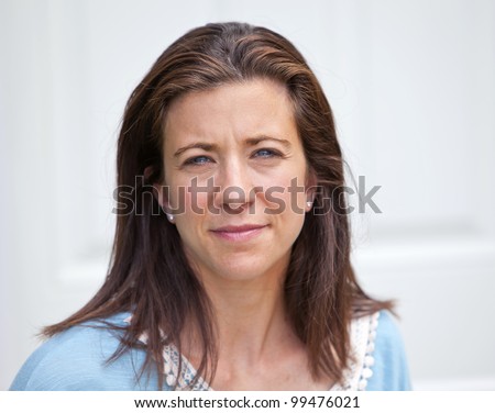 Pretty adult woman looking forward with sad expression
