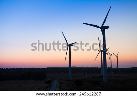 Silhouette wind turbine power with sunset, Sardinia, Italy