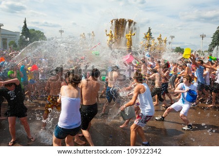 MOSCOW - JULY 14: Young people shooting and throwing water at each other during flash mob \