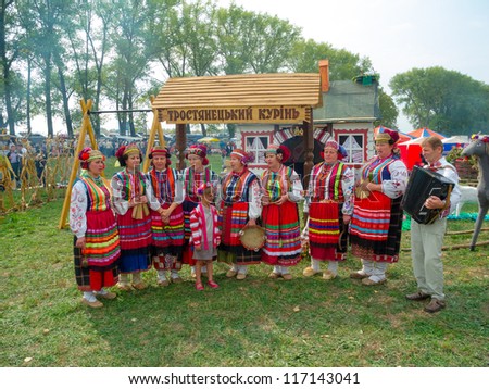 SUMY, UKRAINE - SEPTEMBER 22: Unidentified folk music band performs in traditional village background at annual agro exhibition SUMY-2012 on September 22, 2012 in Sumy, Ukraine