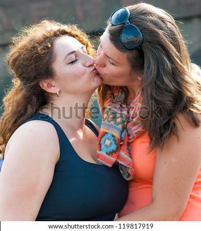 Portrait of two young beautiful women kissing