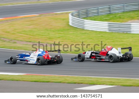 MOSCOW - JUNE 23: Egor Orudzhev (left) of Tech 1 R team (FRA) and Hans Willemi (right) of Atech Reid Team (GBR) races at World Series by Renault in Moscow Raceway on June 23, 2013 in Moscow