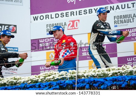 MOSCOW - JUNE 23: The winners of Formula Renault 2.0 race splashing each other with champagne at World Series by Renault in Moscow Raceway on June 23, 2013 in Moscow