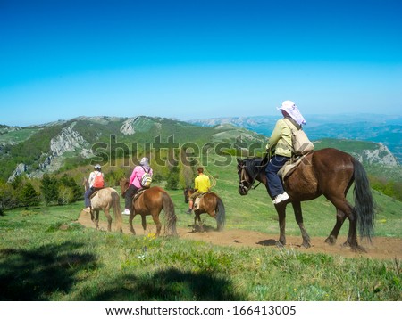 Horse riders traveling in the mountains