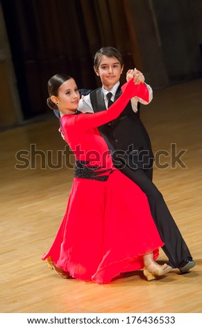 Couple of kids waltzing at dance competition